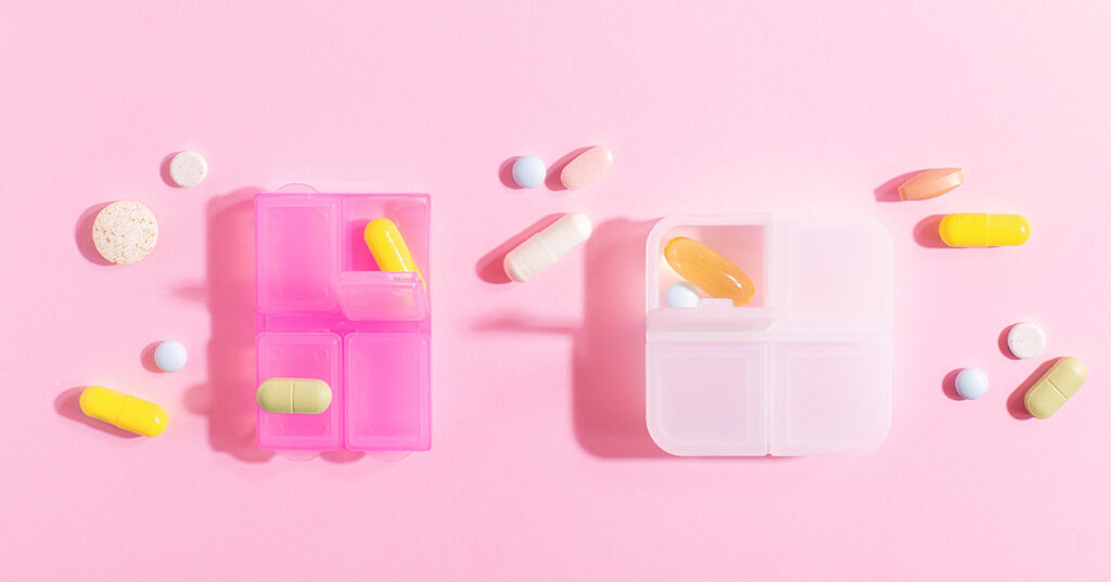 brightly,lit,plastic,organizer,with,colourful,pills,,painkillers,,vitamins,,nutritional
